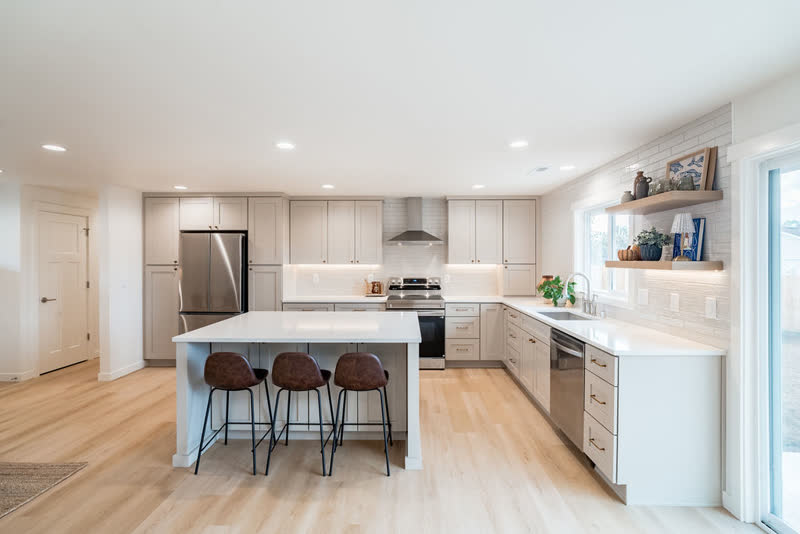 Bright renovated kitchen with island and gray shaker cabinets in East Vancouver, Washington