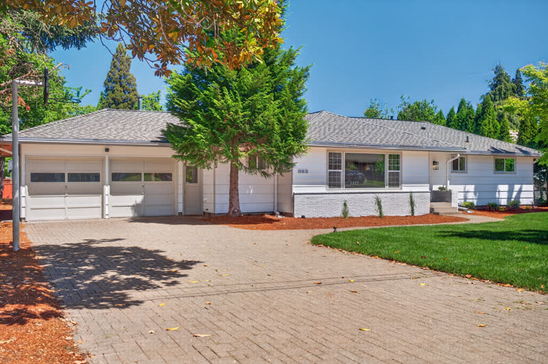Renovated white ranch home with new landscaping and paver driveway in Keizer, Oregon
